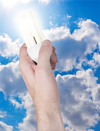 simsearch:400-04900554,k - Glowing Energy Saving Bulb in Hand on Blue Sky Background Photographie de stock - Aubaine LD & Abonnement, Code: 400-05340670