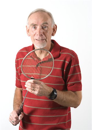 Active senior man holding badminton racket. Isolated on white. Photographie de stock - Aubaine LD & Abonnement, Code: 400-05340920