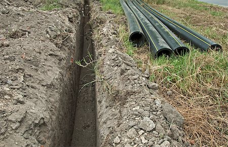 pipework - Black deep plastic pipes and ditch. Foto de stock - Super Valor sin royalties y Suscripción, Código: 400-05341510