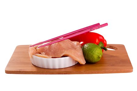 raw chicken on cutting board - Raw chicken breast and vegetables on a cutting board with chopsticks. Stock Photo - Budget Royalty-Free & Subscription, Code: 400-05341578