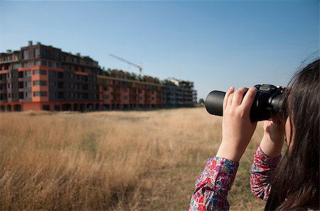 skyscraper company suit - Woman watching with binoculars big building construction. Stock Photo - Budget Royalty-Free & Subscription, Code: 400-05342007