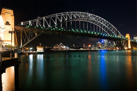 simsearch:400-05740624,k - Sydney Harbour Bridge By Night with sparkling water reflection. The Sydney Opera House is at the background. Stock Photo - Budget Royalty-Free & Subscription, Code: 400-05342447