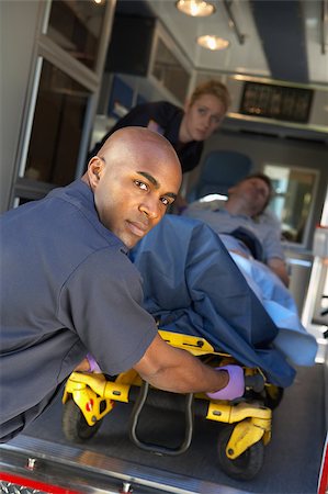 Paramedics preparing to unload patient on gurney Stock Photo - Budget Royalty-Free & Subscription, Code: 400-05343071