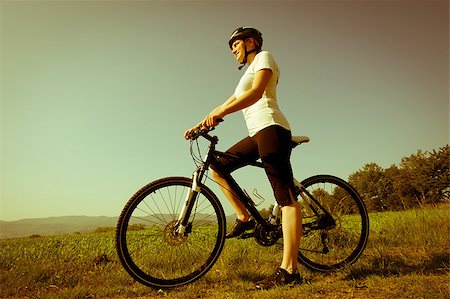 simsearch:400-04890875,k - Young girl riding a bike on a field path - offroad Stock Photo - Budget Royalty-Free & Subscription, Code: 400-05343284