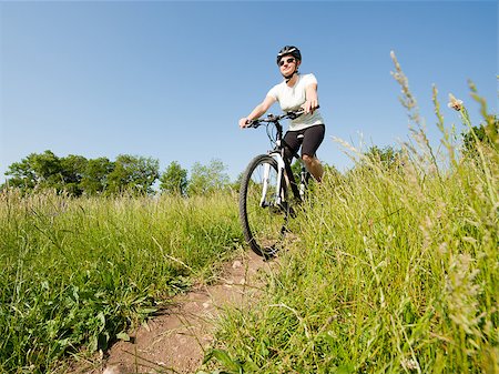 simsearch:400-04890875,k - Young girl riding a bike on a field path - offroad Stock Photo - Budget Royalty-Free & Subscription, Code: 400-05343286