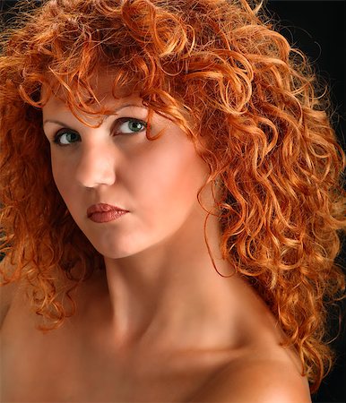 Young woman's head and shoulders portrait on black background. She has fantastic curly red hair and green eyes Foto de stock - Super Valor sin royalties y Suscripción, Código: 400-05343443