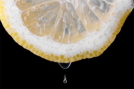 Lemon and drops over a dark background Stock Photo - Budget Royalty-Free & Subscription, Code: 400-05343617