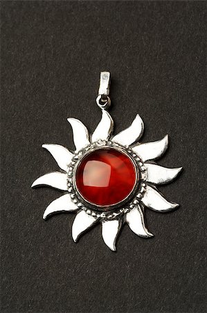 Silver sun pendant with beautiful cornelian gemstone. Fotografie stock - Microstock e Abbonamento, Codice: 400-05343663