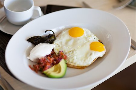 simsearch:400-06094801,k - sunny side up eggs served on a toast with sliced avocado, salsa and sour cream Photographie de stock - Aubaine LD & Abonnement, Code: 400-05343697