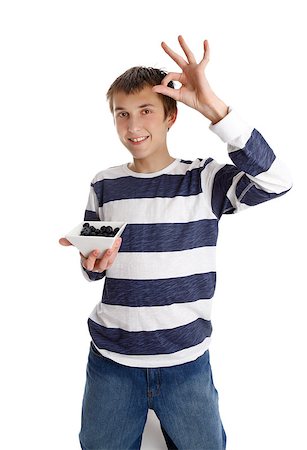 A boy holding a small bowl of blueberries and showing an a-ok hand sign Stock Photo - Budget Royalty-Free & Subscription, Code: 400-05343989