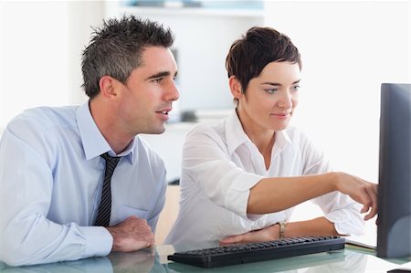 simsearch:400-04918393,k - Businesswoman showing something on a screen to her colleague in an office Stock Photo - Budget Royalty-Free & Subscription, Code: 400-05354002