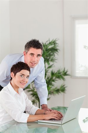 simsearch:400-04918393,k - Portrait of a manager and his secretary posing with a laptop in an office Stock Photo - Budget Royalty-Free & Subscription, Code: 400-05354010