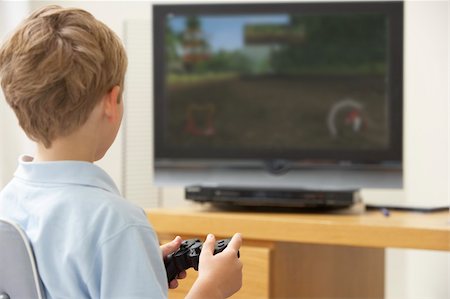 Young Boy Playing With Game Console Photographie de stock - Aubaine LD & Abonnement, Code: 400-05354732