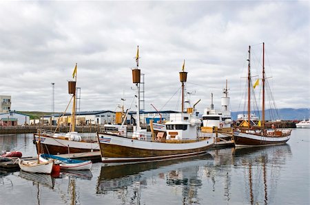 Boats, used to take tourists on whale watching trips wait for new passengers in Husavik, Iceland Stock Photo - Budget Royalty-Free & Subscription, Code: 400-05355275