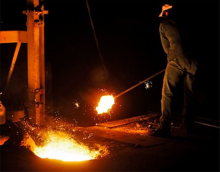 sparks of molten metal - A man working in a cast iron factory close to the melting pit of the foundry Stock Photo - Budget Royalty-Free & Subscription, Code: 400-05355651