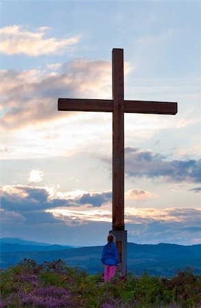 simsearch:400-04306537,k - Small girl near wooden cross on summer heather flower hill top and evening country view behind Stock Photo - Budget Royalty-Free & Subscription, Code: 400-05355978