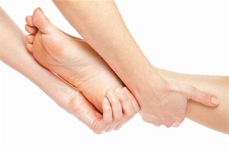 female foot massage - Mains de femme donnant un massage des pieds doux isolé sur fond blanc Photographie de stock - Aubaine LD & Abonnement, Code: 400-05356137