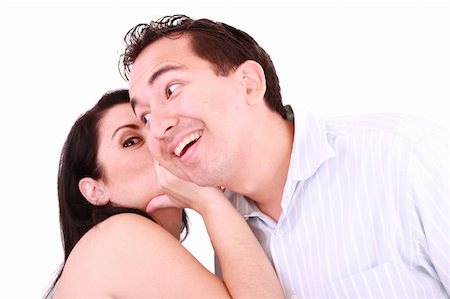 simsearch:400-03926791,k - pretty girl talking secret to young man in his ear, man smiling over isolated white background Stockbilder - Microstock & Abonnement, Bildnummer: 400-05356364