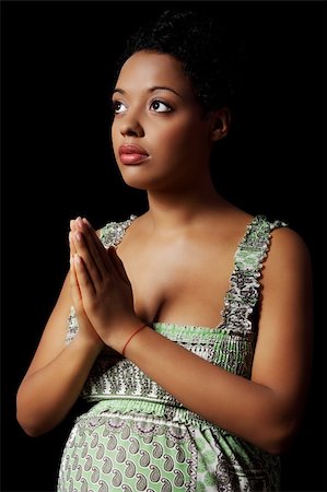 simsearch:693-03308178,k - Young beautiful  american pregnant woman praying against black background Stock Photo - Budget Royalty-Free & Subscription, Code: 400-05356493