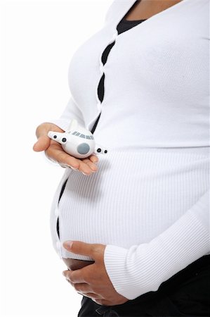 simsearch:400-04396054,k - Pregnant woman holding  small plane (pregnant traveling concept) , isolated on white background Photographie de stock - Aubaine LD & Abonnement, Code: 400-05356514