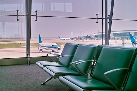 raywoo (artist) - Departure hall of the airport with the view of plane Fotografie stock - Microstock e Abbonamento, Codice: 400-05356568
