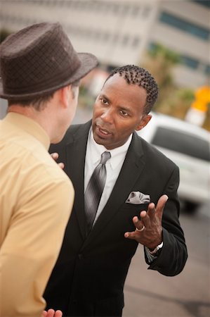 Handsome African-American businessman arguing with his colleague Stock Photo - Budget Royalty-Free & Subscription, Code: 400-05356850