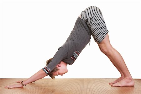 simsearch:400-04328141,k - Young Caucasian man in Adho Mukha Svanasana Yoga posture over white background Stock Photo - Budget Royalty-Free & Subscription, Code: 400-05356872