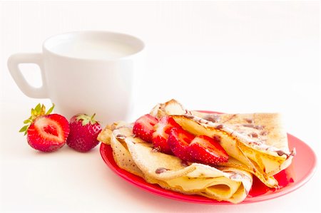 sweet pancakes with strawberry and cup of milk on white background Foto de stock - Super Valor sin royalties y Suscripción, Código: 400-05357010