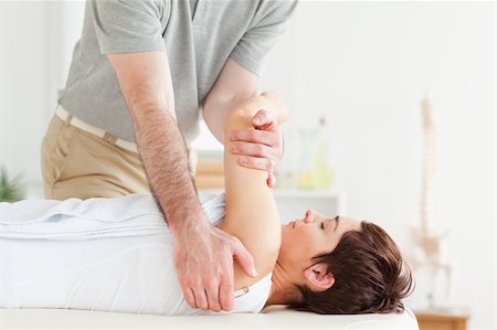 Man stretching a woman's arm in a room Photographie de stock - Aubaine LD & Abonnement, Code: 400-05357089