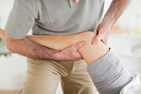 physical therapy shoulder - Chiropractor massaging a patient's knee in a room Stock Photo - Budget Royalty-Free & Subscription, Code: 400-05357096
