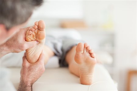 Lying Woman getting a reflexology massage by a man Stockbilder - Microstock & Abonnement, Bildnummer: 400-05357105