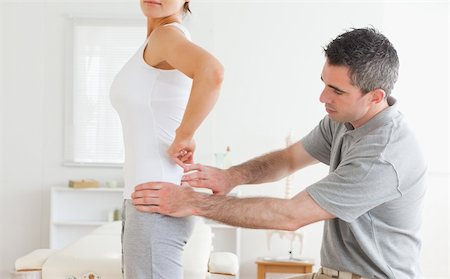 physical therapy shoulder - Chiropractor examining a charming woman's back in a room Stock Photo - Budget Royalty-Free & Subscription, Code: 400-05357134