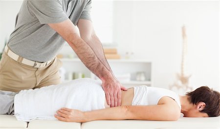 Man massaging a cute woman's back in a room Stockbilder - Microstock & Abonnement, Bildnummer: 400-05357148