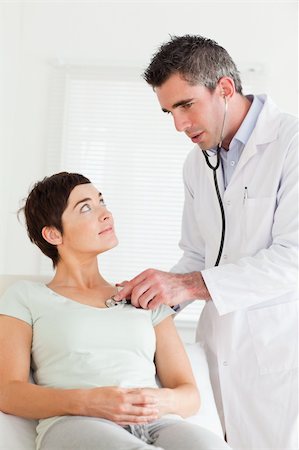 Male Doctor examining a female patient in a room Stock Photo - Budget Royalty-Free & Subscription, Code: 400-05357167