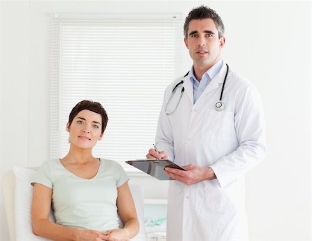 Doctor and patient looking into a camera in a room Stock Photo - Budget Royalty-Free & Subscription, Code: 400-05357162