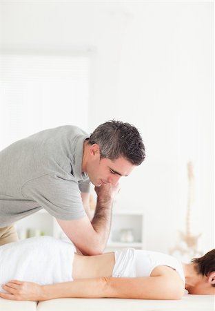 physical therapy shoulder - Chiropractor doing accupressure on a woman's back in a room Stock Photo - Budget Royalty-Free & Subscription, Code: 400-05357163