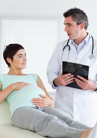 Doctor talking to a pregnant woman in a room Stock Photo - Budget Royalty-Free & Subscription, Code: 400-05357214