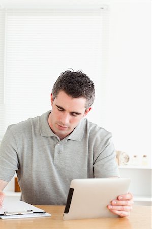 Doctor sitting at a table with a tablet and a chart in a room Stock Photo - Budget Royalty-Free & Subscription, Code: 400-05357262