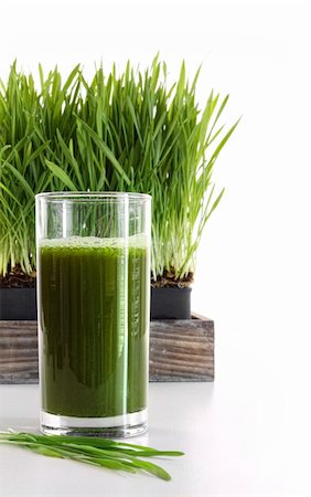 Glass of wheatgrass against a white background Foto de stock - Super Valor sin royalties y Suscripción, Código: 400-05357310