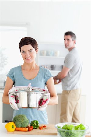 simsearch:400-05357733,k - Woman holding a pot while man is washing the dishes Fotografie stock - Microstock e Abbonamento, Codice: 400-05357333