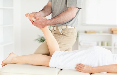 physical therapy shoulder - A masseur is massaging a woman's foot in his surgery Stock Photo - Budget Royalty-Free & Subscription, Code: 400-05357449