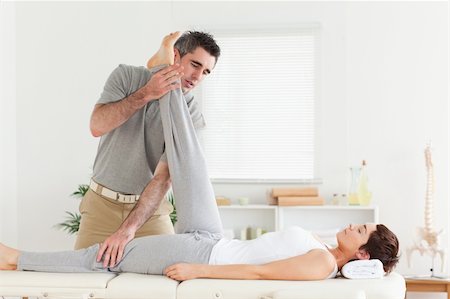 A chiropractor is exercising with a woman Stockbilder - Microstock & Abonnement, Bildnummer: 400-05357474