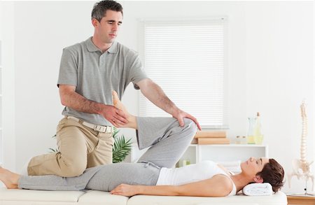 A chiropractor is stretching a customer's leg Stock Photo - Budget Royalty-Free & Subscription, Code: 400-05357475