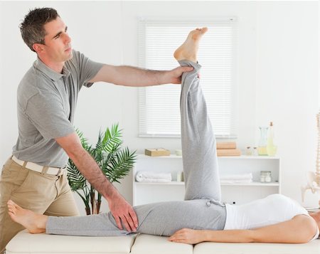 A chiropractor is exercising with a customer Stockbilder - Microstock & Abonnement, Bildnummer: 400-05357477