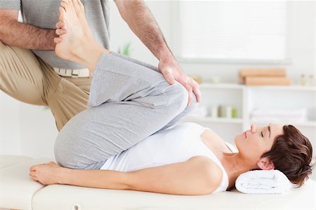 A chiropractor is stretching a woman's legs Stockbilder - Microstock & Abonnement, Bildnummer: 400-05357480