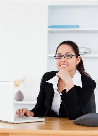 simsearch:400-04894274,k - A young businesswoman with glasses sitting at her workplace Stock Photo - Budget Royalty-Free & Subscription, Code: 400-05357496