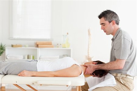 physical therapy shoulder - A chiropractor is massaging a woman's neck in his surgery Stock Photo - Budget Royalty-Free & Subscription, Code: 400-05357490