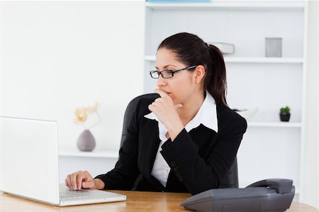 simsearch:400-04894274,k - A serious young businesswoman sitting by her laptop in her office Stock Photo - Budget Royalty-Free & Subscription, Code: 400-05357621
