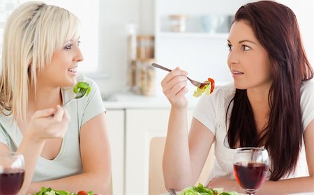 simsearch:400-05357667,k - Joyful Women eating salad in a kitchen Stock Photo - Budget Royalty-Free & Subscription, Code: 400-05357647