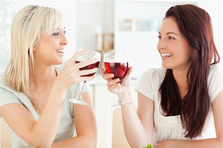 simsearch:400-05357667,k - Joyful women toasting with wine in a kitchen Stock Photo - Budget Royalty-Free & Subscription, Code: 400-05357641